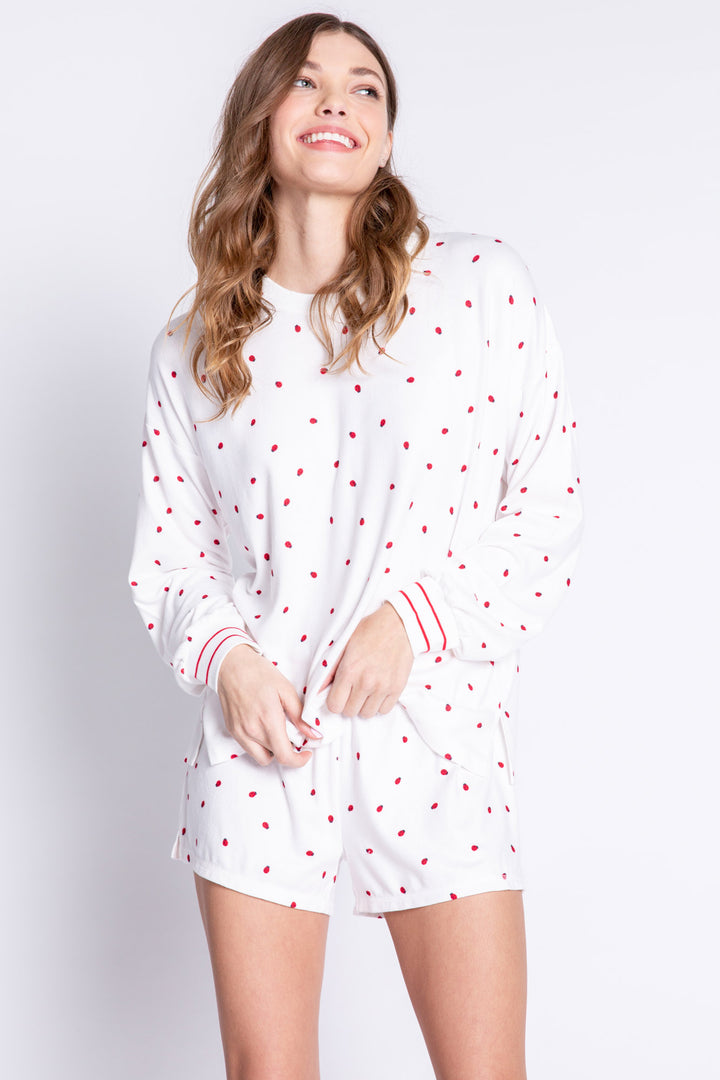Soft ivory lounge top with lady bug print and striped red cuffs. Relaxed fit. (6639335997540)