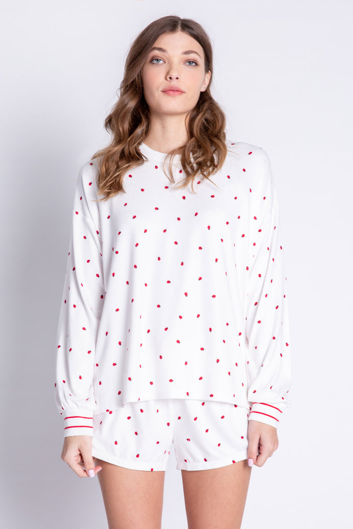 Soft ivory lounge top with lady bug print and striped red cuffs. Relaxed fit. (6639335997540)