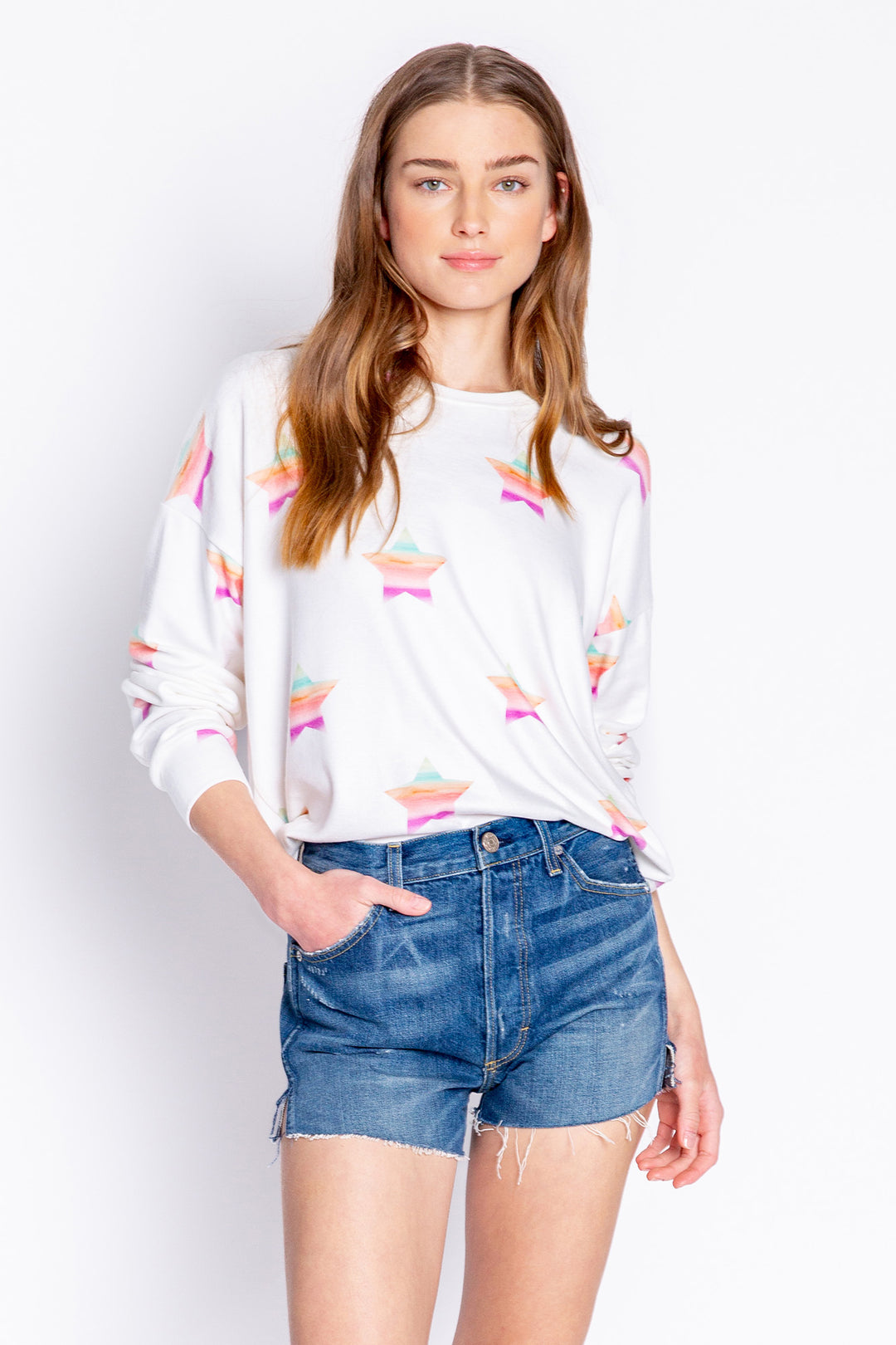 Soft ivory long sleeve top with multi-color gradient star print. Relaxed fit with open hem. (6839656611940)