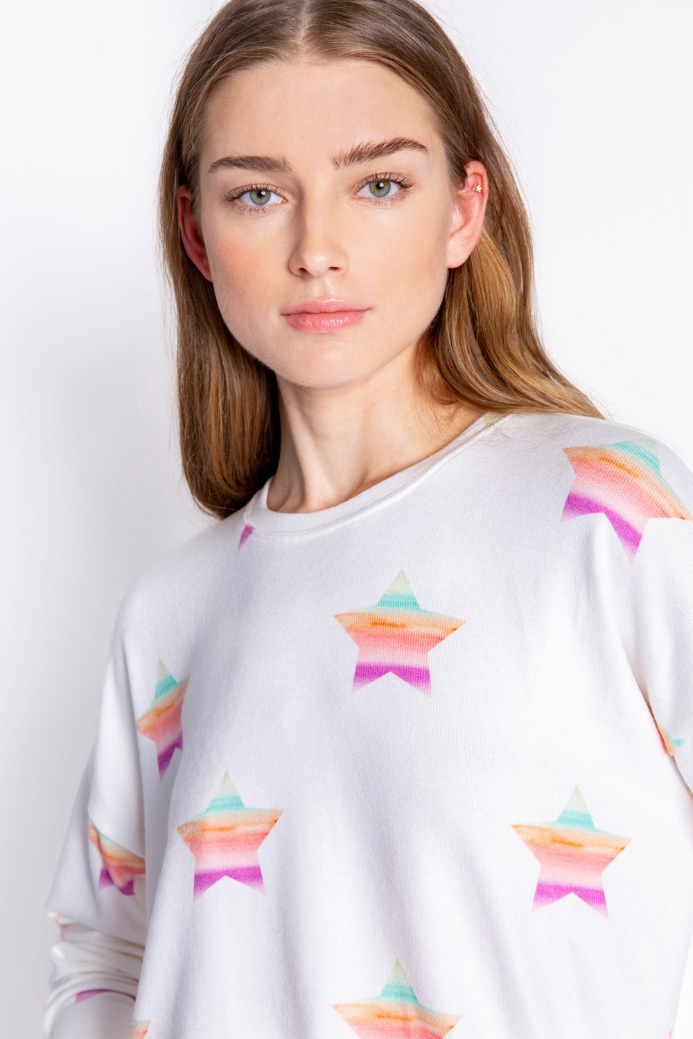 Soft ivory long sleeve top with multi-color gradient star print. Relaxed fit with open hem. (6839656611940)