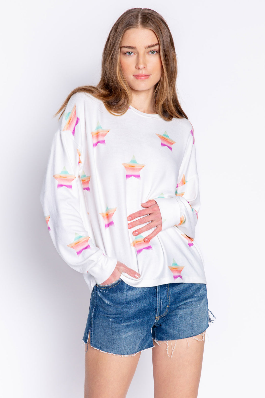 Soft ivory long sleeve top with multi-color gradient star print. Relaxed fit with open hem. (6839656611940)