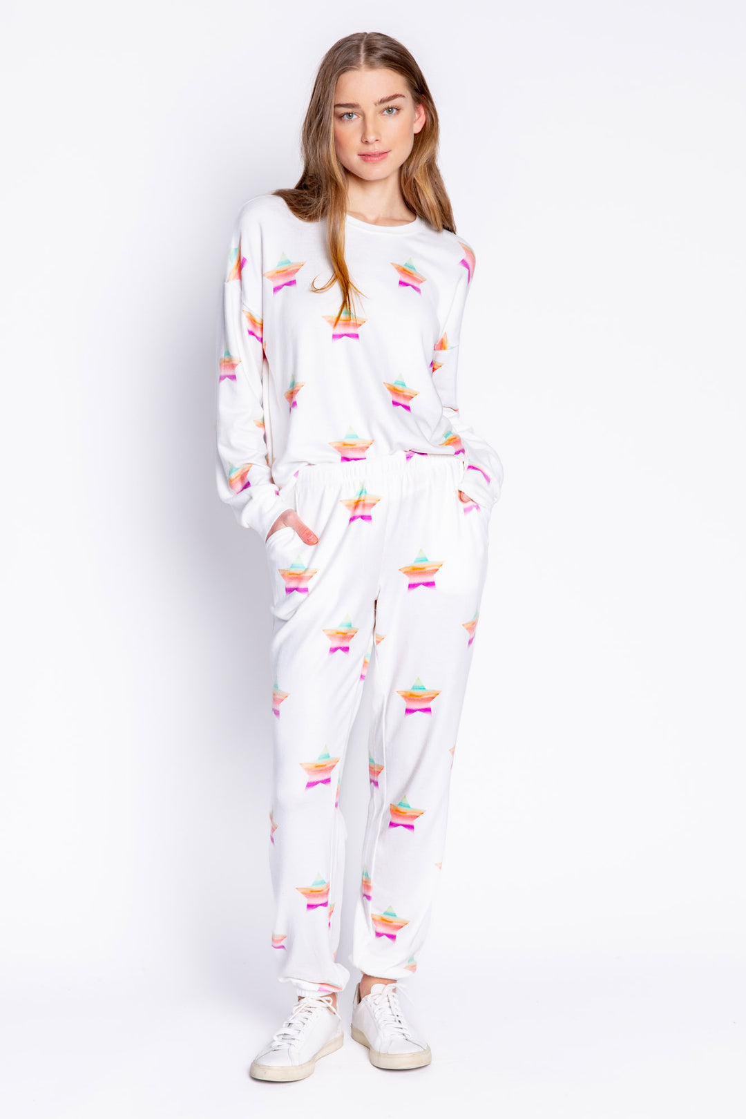 Soft ivory long sleeve top with multi-color gradient star print. Relaxed fit with open hem. (6839656611940)