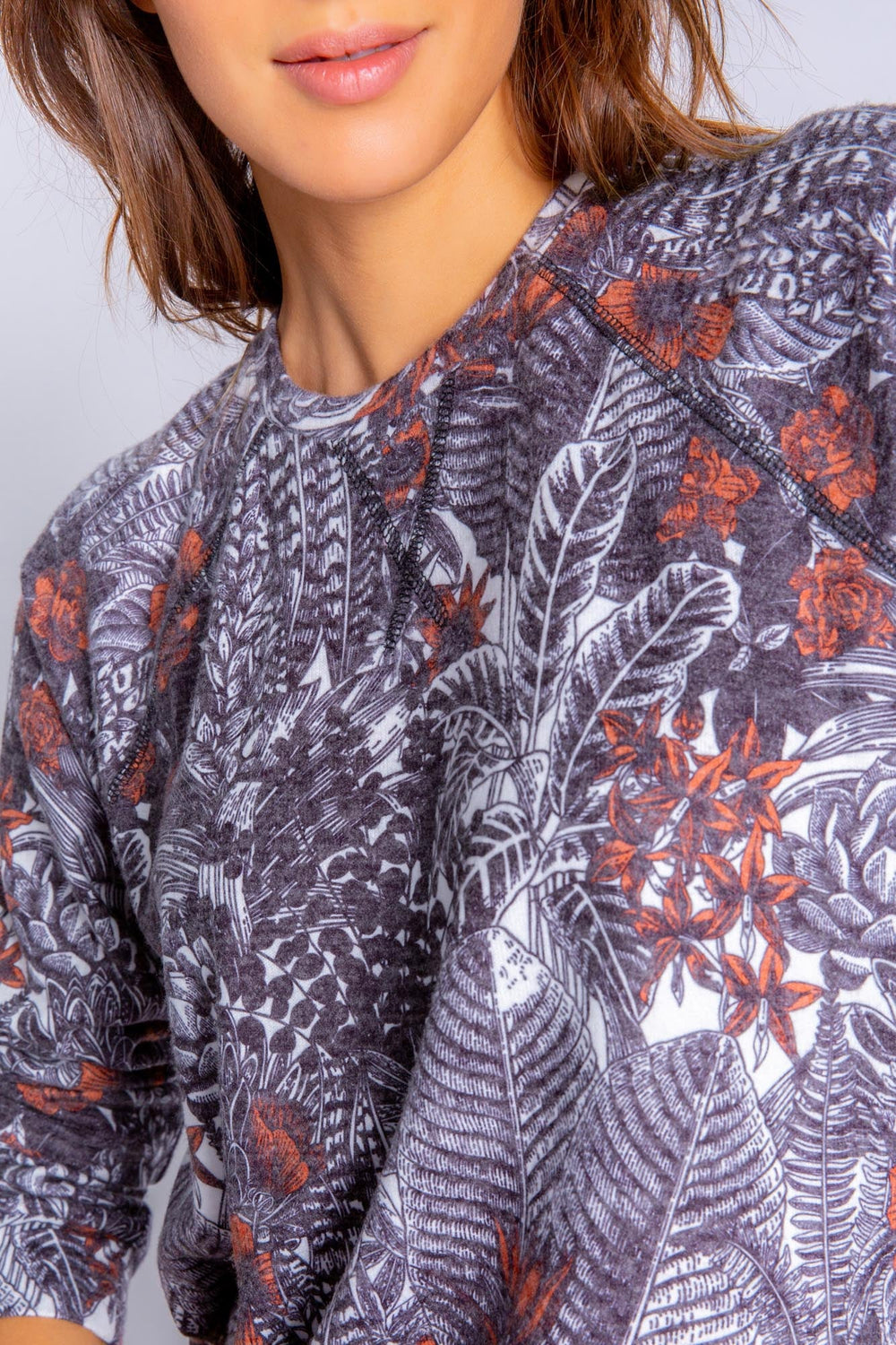 Peachy lounge top in exotic floral-feather print. Relaxed fit pullover with banded cuffs. (6839647567972)